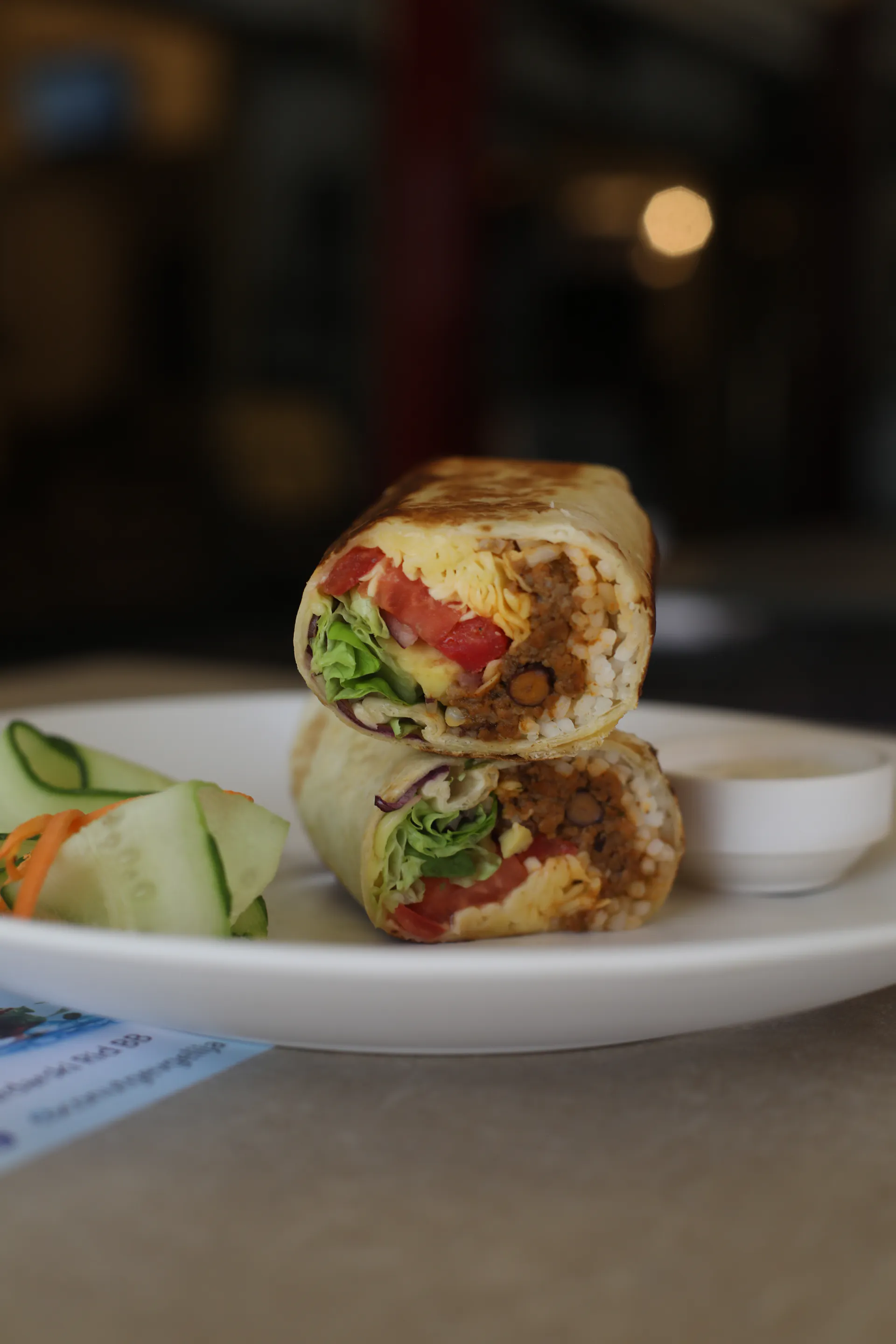 A wrap cut in half, served on a plate at the Hotel Restaurant