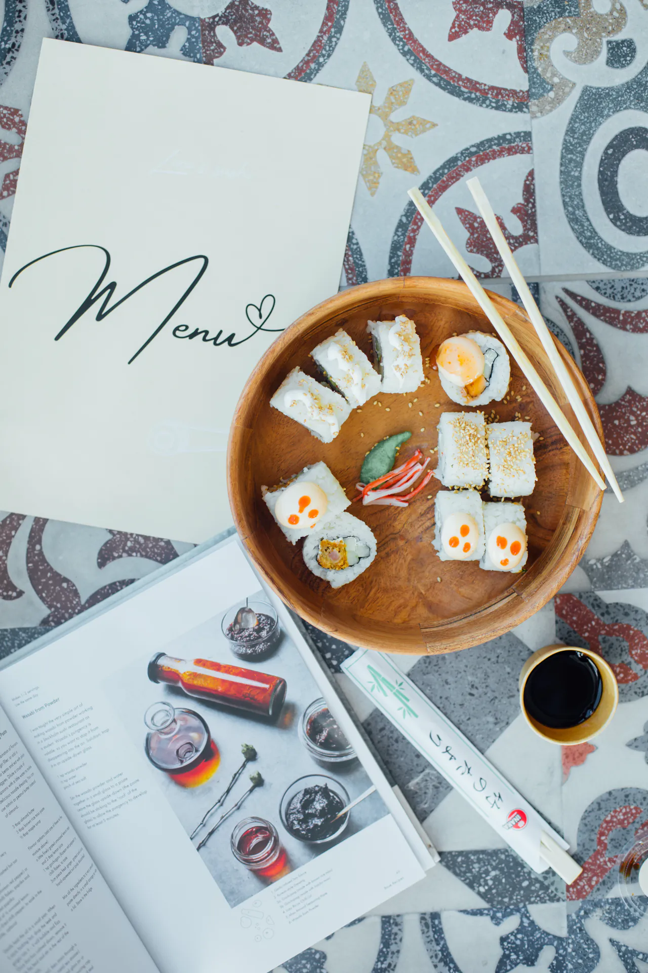 A sushi platter and an iced coffee on a table at the Pool and Lounge Bar