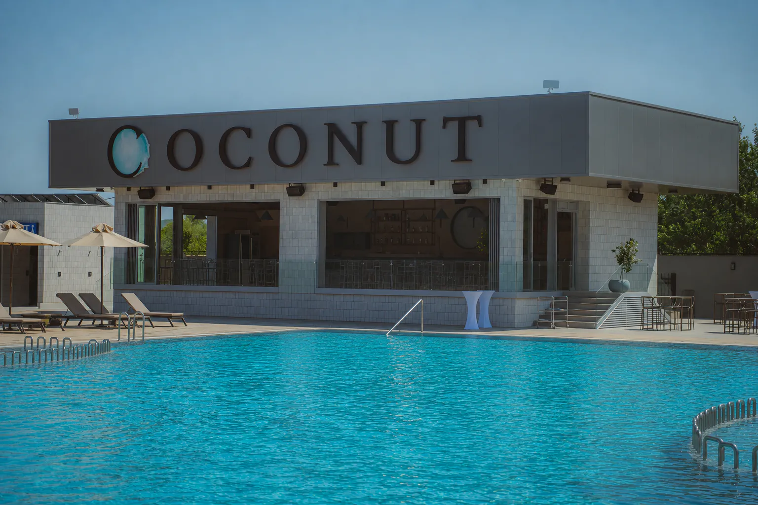 The Coconut pool and the building behind it on a clear summer day